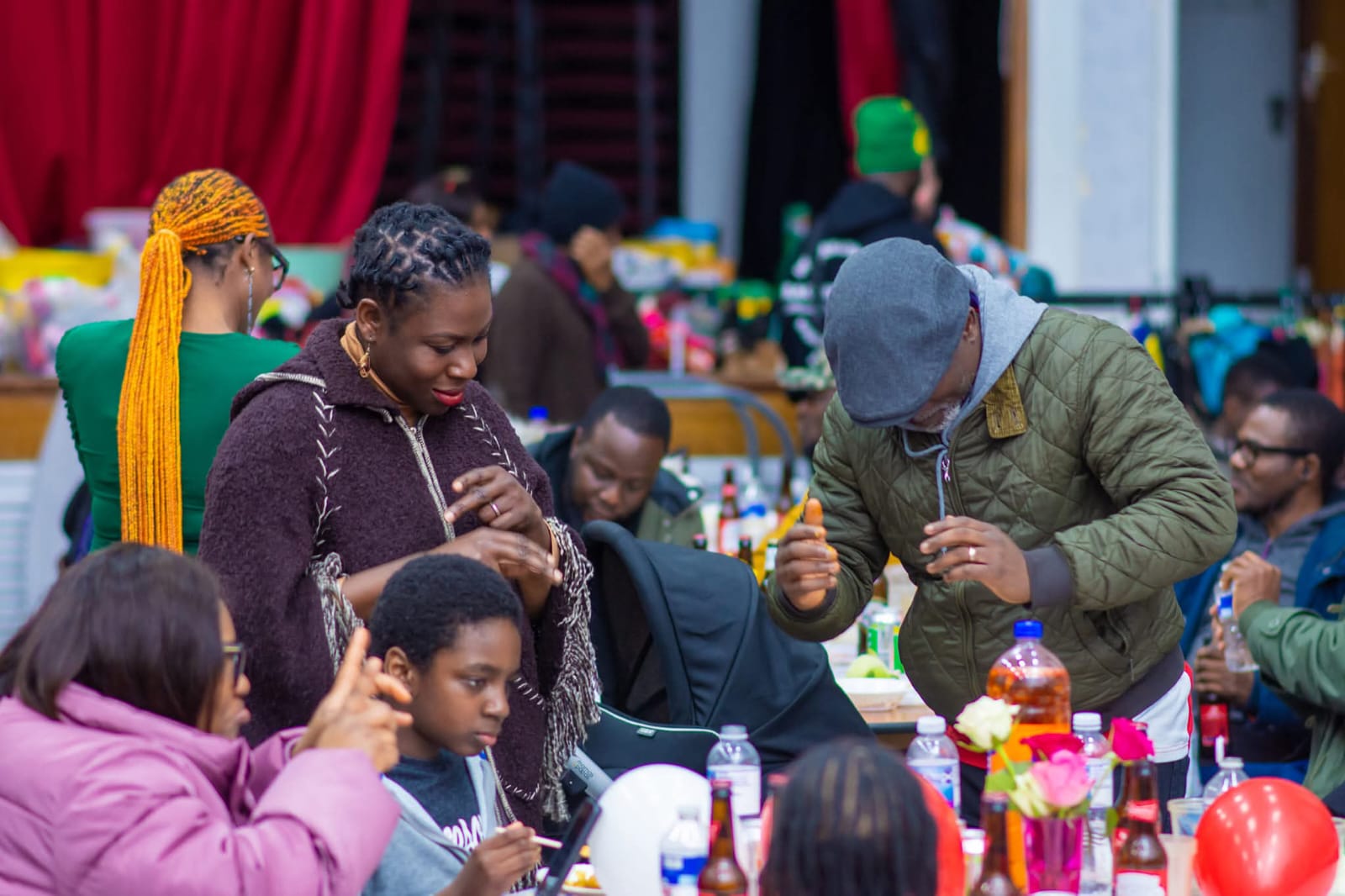 Woman with braids interacting with children at event