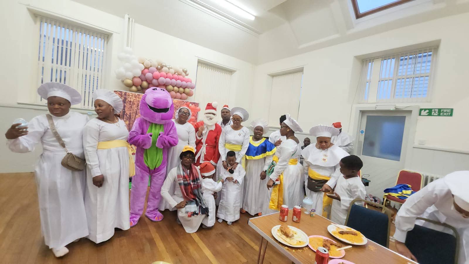 Volunteers in chef outfits with children and festive characters