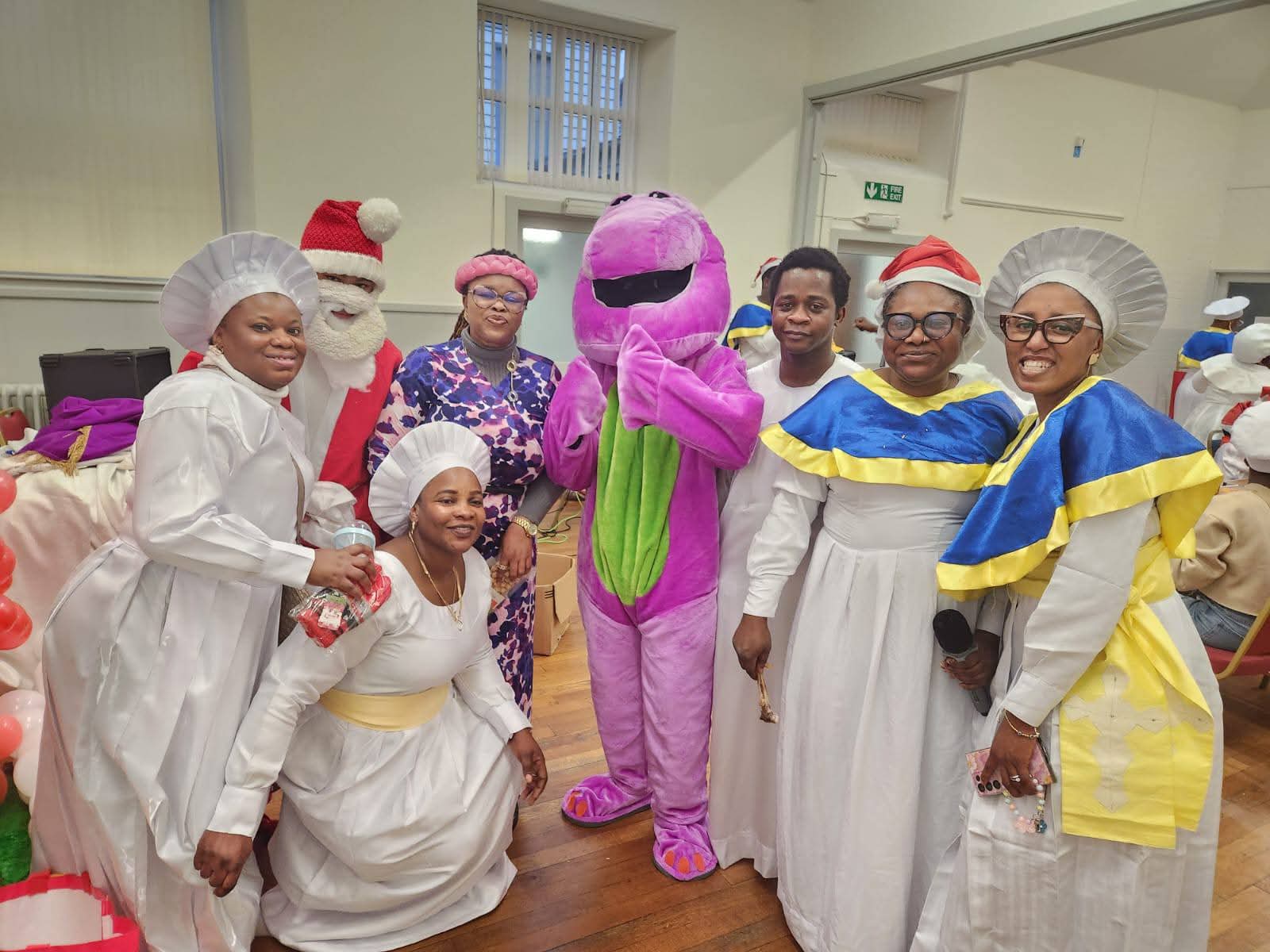 Group of volunteers in chef costumes with children