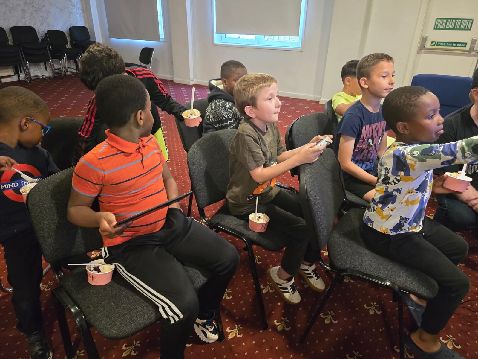 Group of children enjoying snacks and ice cream at event
