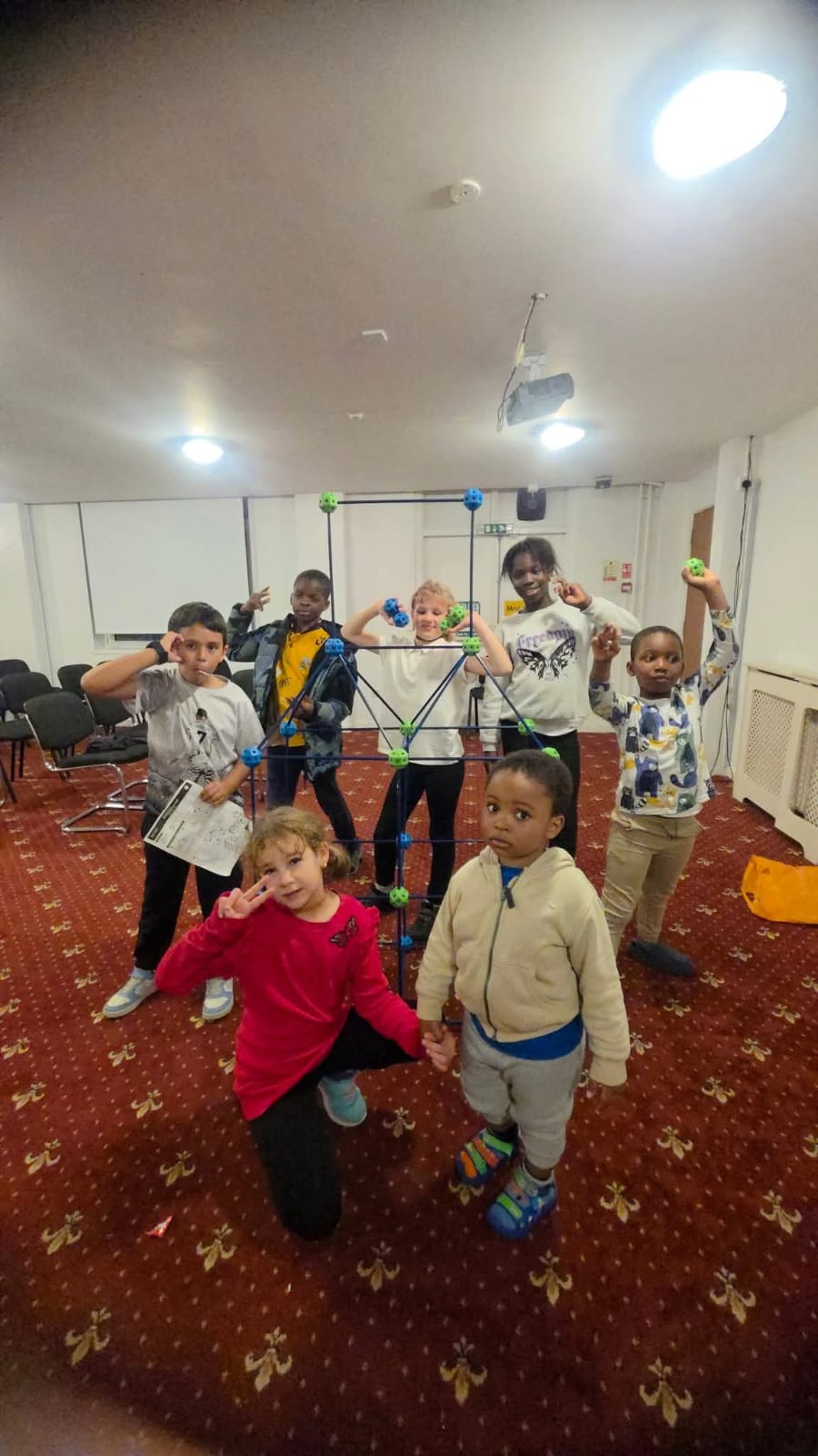 Children with geometric structures at community event