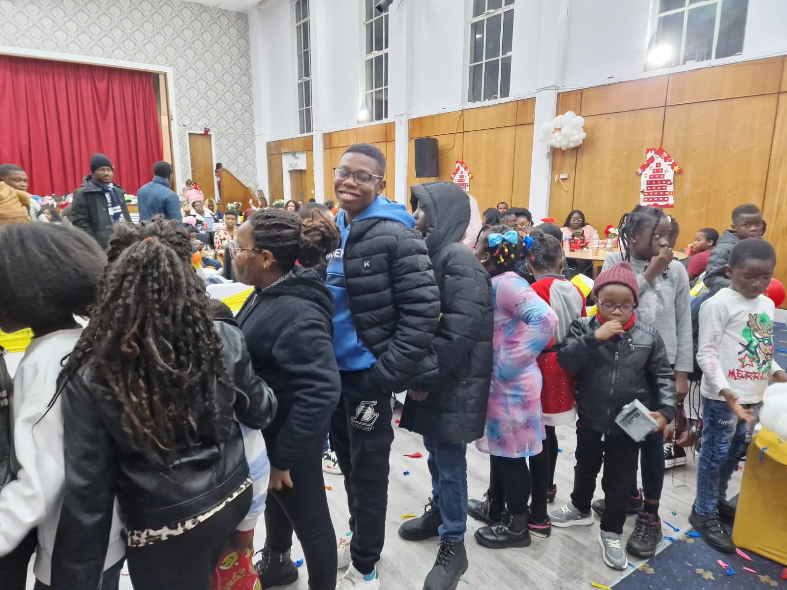 Young man smiling at crowded community event